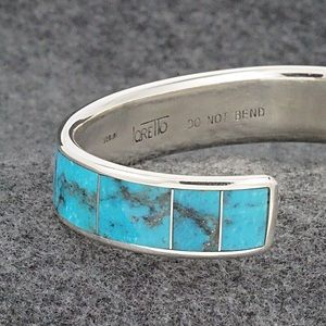 A stunning in-laid sterling silver/turquoise bracelet by artist Larry Loretto.